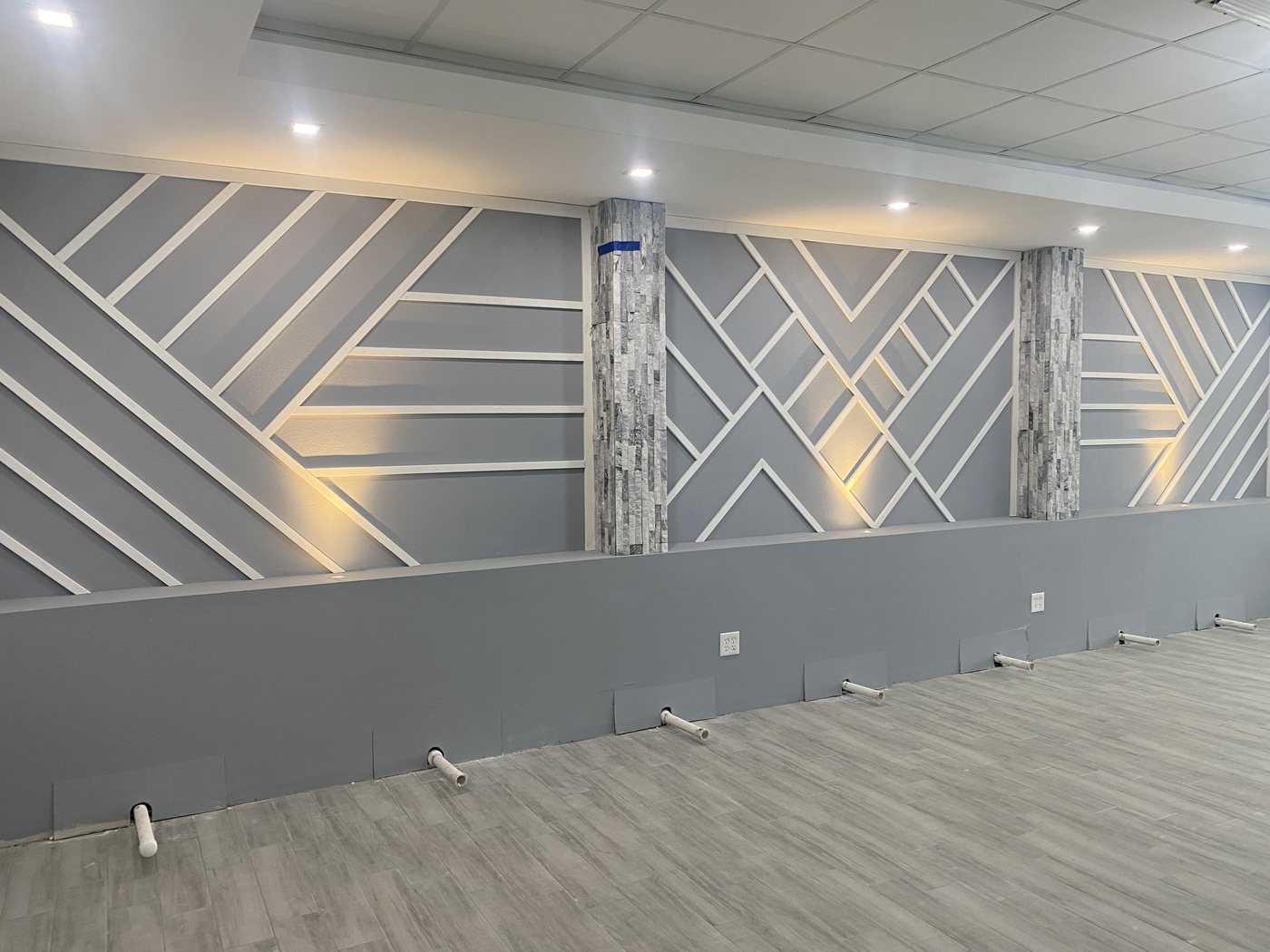 Commercial interior with a full-length lit accent wall in a salon build-out