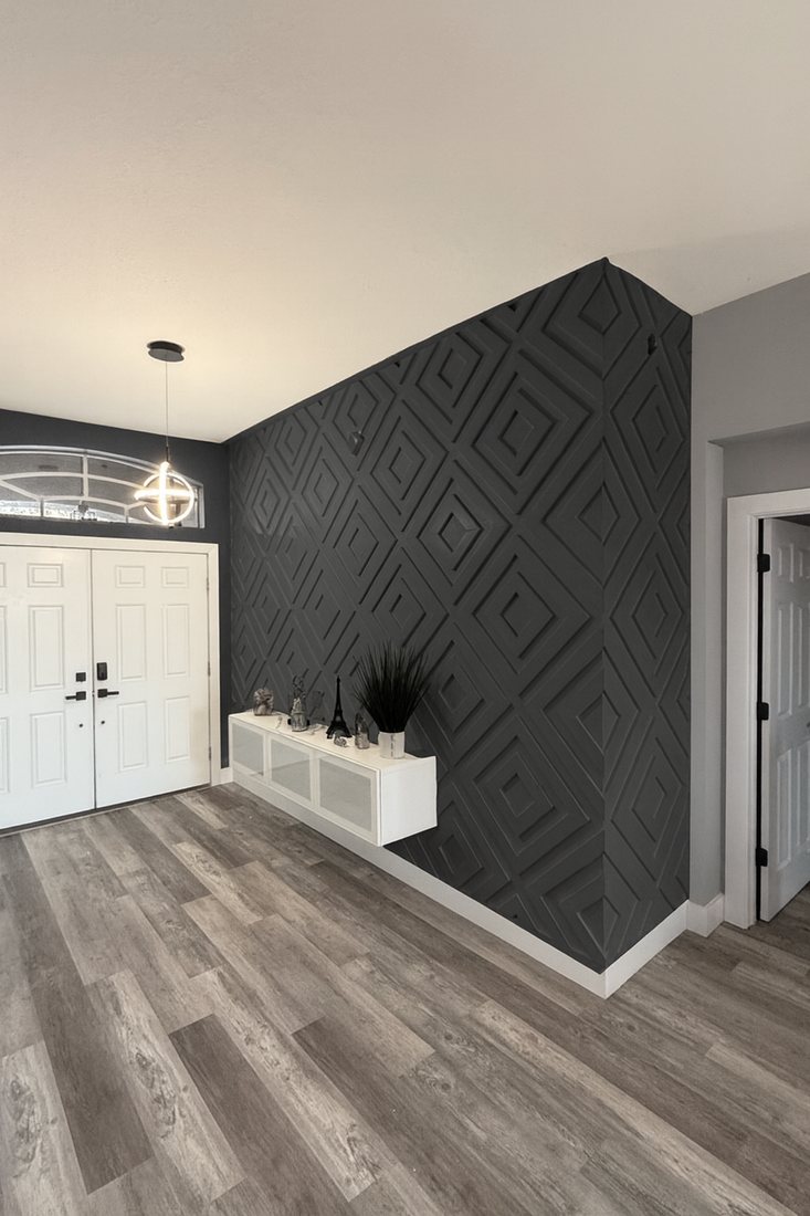 Charcoal entry wall with a repeating diamond molding pattern