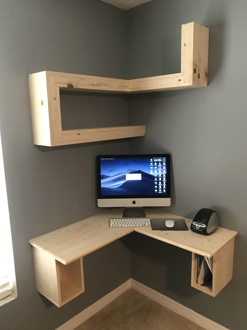 Floating corner desk and shelving built into the wall