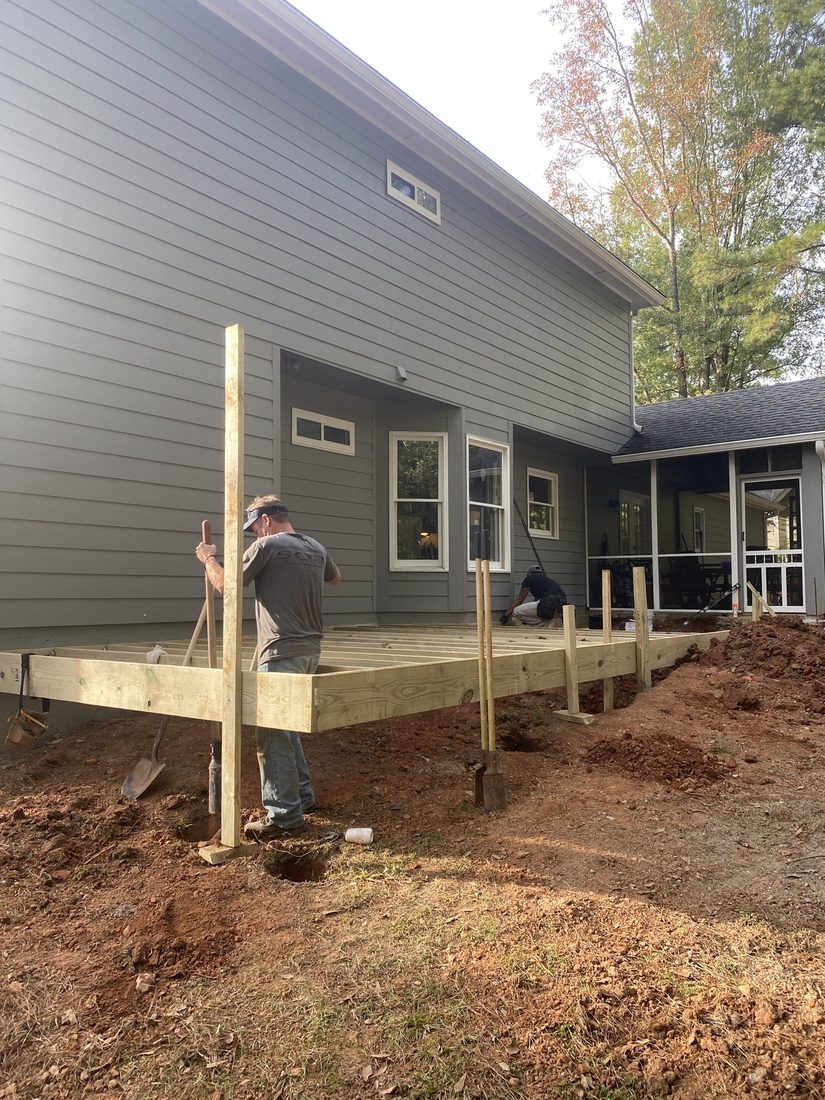 Deck framing and posts going up against the house