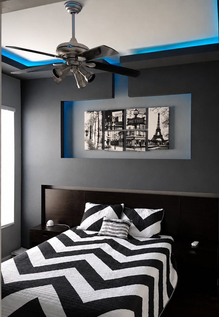 Bedroom with a black accent wall, cove lighting, and a floating headboard