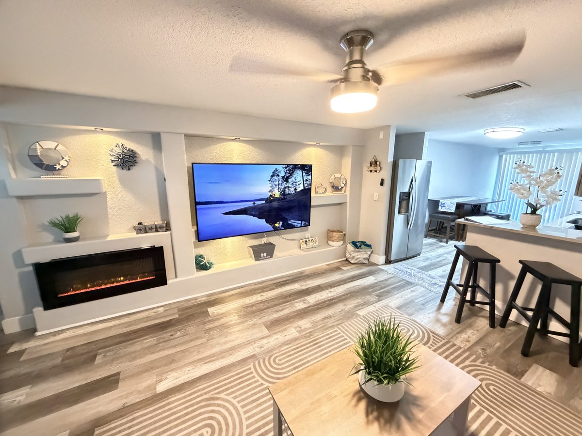Living room with built-in electric fireplace and media wall