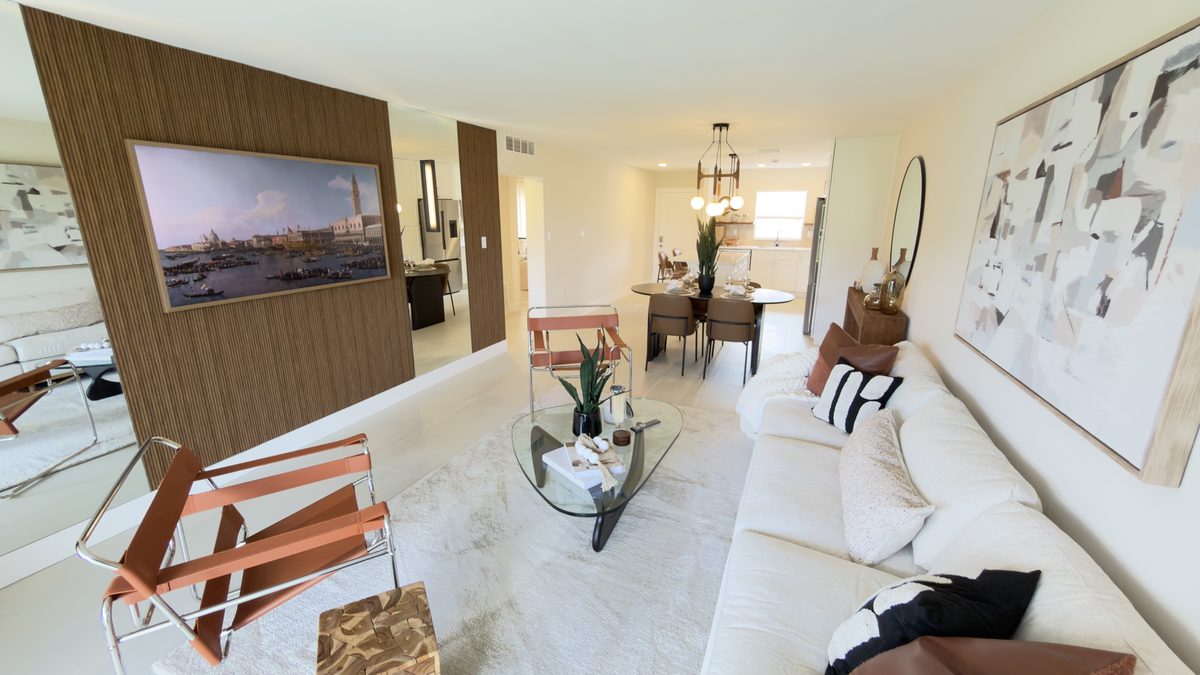 Renovated living and dining space with a wood feature wall