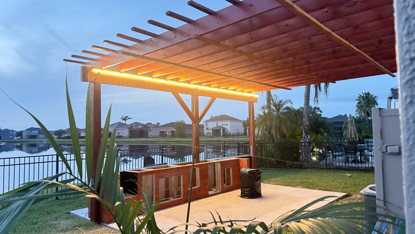 Covered outdoor structure with integrated lighting